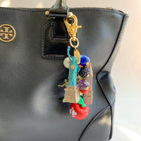 New York City bag charm . New York City keychain with colorful beads and statue of liberty charm, Prometheus charm, and Chrysler Building charm.