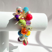 Colorful beaded bracelet for women. Assorted unique beads in a wide range for colors, texture, and shape wire wrapped on a solid and sturdy brass plated chain with lobster clasp.