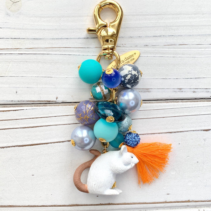Blue beaded bag charm with white mouse charm at the bottom and gold trigger clasp at top. Cute bag charms for handbags.