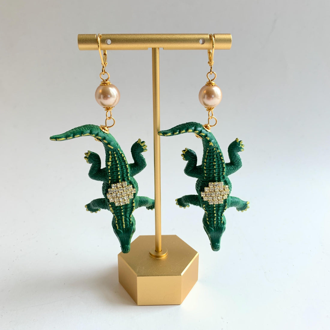Alligator earrings with green alligators gilded with gold and embellished with rhinestones.