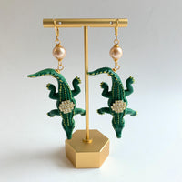 Alligator earrings with green alligators gilded with gold and embellished with rhinestones.