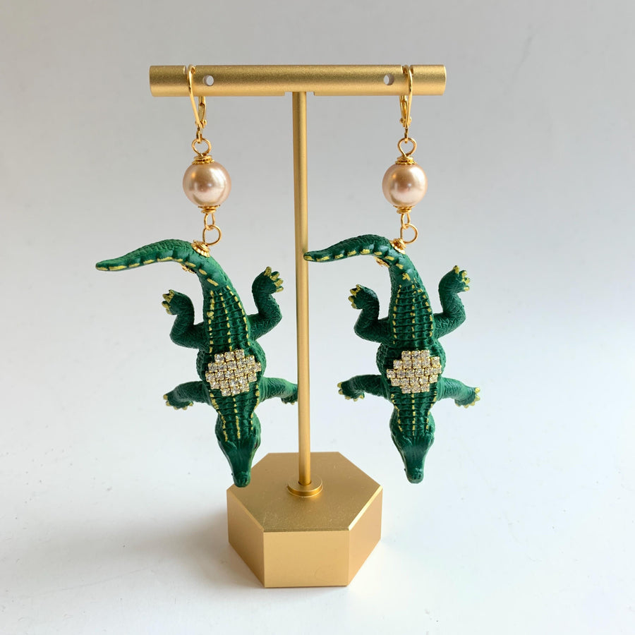 Alligator earrings with green alligators gilded with gold and embellished with rhinestones.
