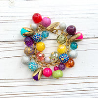 Colorful beaded bracelet for women. Assorted unique beads in a wide range for colors, texture, and shape wire wrapped on a solid and sturdy brass plated chain with lobster clasp.