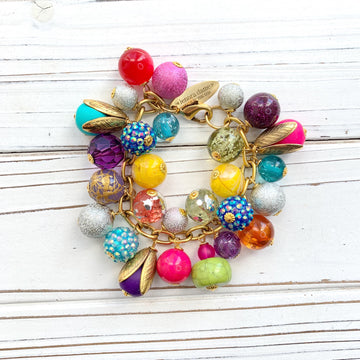 Colorful beaded bracelet for women. Assorted unique beads in a wide range for colors, texture, and shape wire wrapped on a solid and sturdy brass plated chain with lobster clasp.