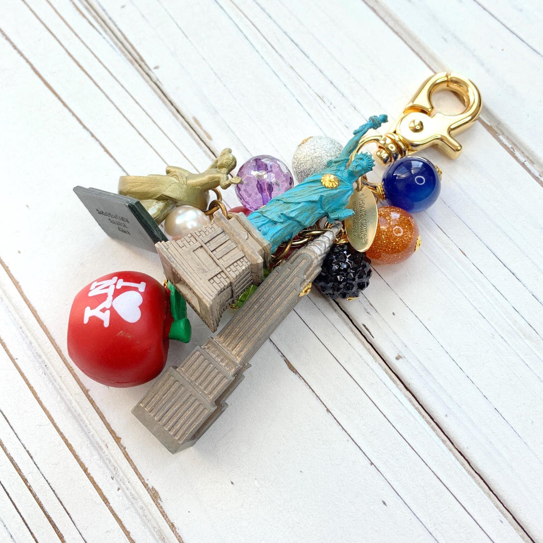 New York City bag charm . New York City keychain with colorful beads and statue of liberty charm, Prometheus charm, and Chrysler Building charm.
