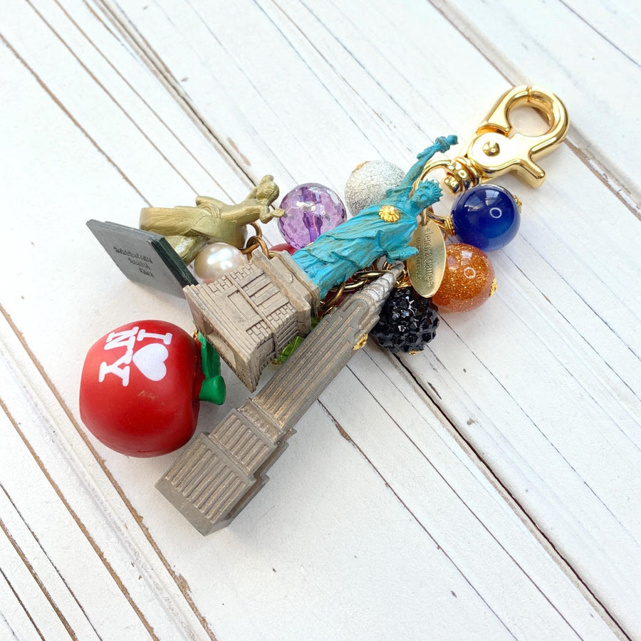 New York City bag charm . New York City keychain with colorful beads and statue of liberty charm, Prometheus charm, and Chrysler Building charm.