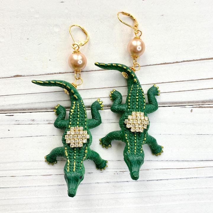 Alligator earrings with green alligators gilded with gold and embellished with rhinestones.