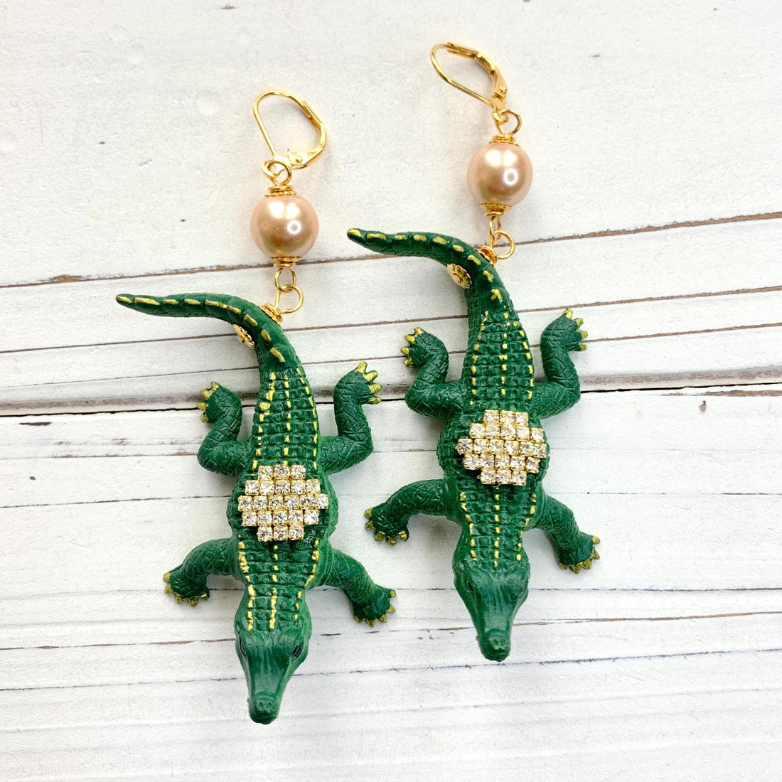 Alligator earrings with green alligators gilded with gold and embellished with rhinestones.