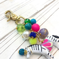 Colorful beaded bag charm with zebra figurine. Lenora Dame bag charms.