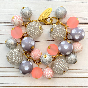 Lenora Dame chunky bracelet with pink, peach, grey and silver beads on a gold chain.