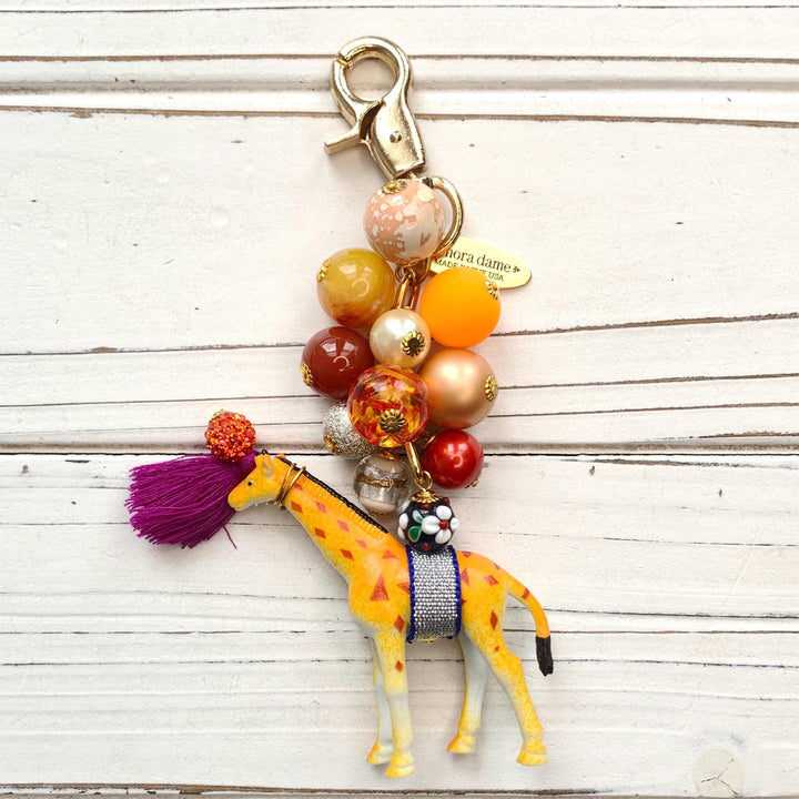 Cute beaded bag charm  with embellished giraffe figurine. Lenora Dame bag charms.