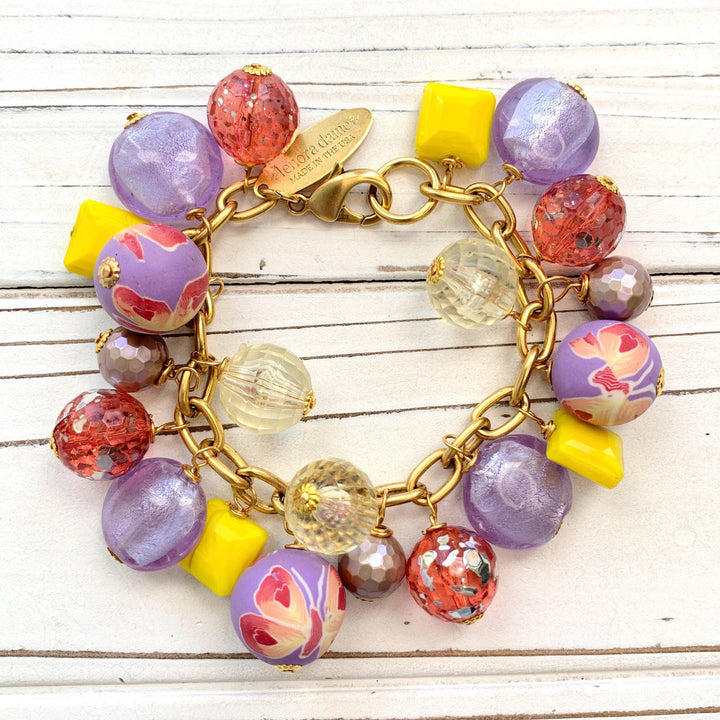 Lenora Dame bracelet. Purple and yellow beaded bracelet with beads wire wrapped on a gold plated steel chain with lobster clasp.