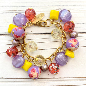 Lenora Dame bracelet. Purple and yellow beaded bracelet with beads wire wrapped on a gold plated steel chain with lobster clasp.