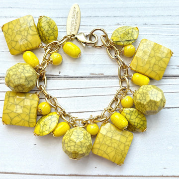 Yellow beaded bracelet for women with square, oval, and round yellow beads with a black crack design wire wrapped on a gold chain with lobster clasp and Lenora Dame Made in USA hang tag. Lenora Dame bracelet.