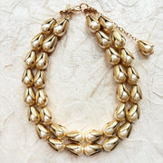 Two strand gold necklace with cream pearls encased in gold leaf bead caps. Lenora Dame necklace.