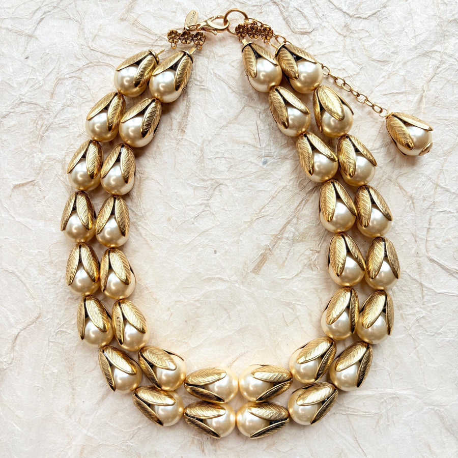 Two strand gold necklace with cream pearls encased in gold leaf bead caps. Lenora Dame necklace.